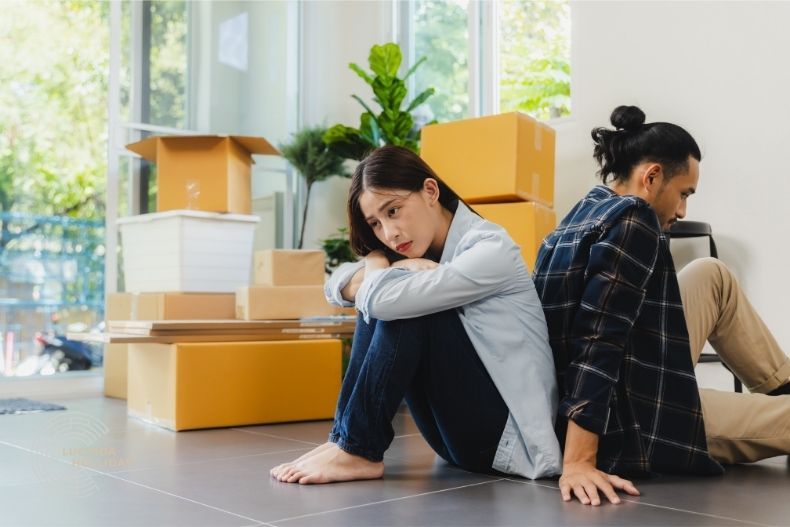 Asian couple facing separation or divorce sitting back to back