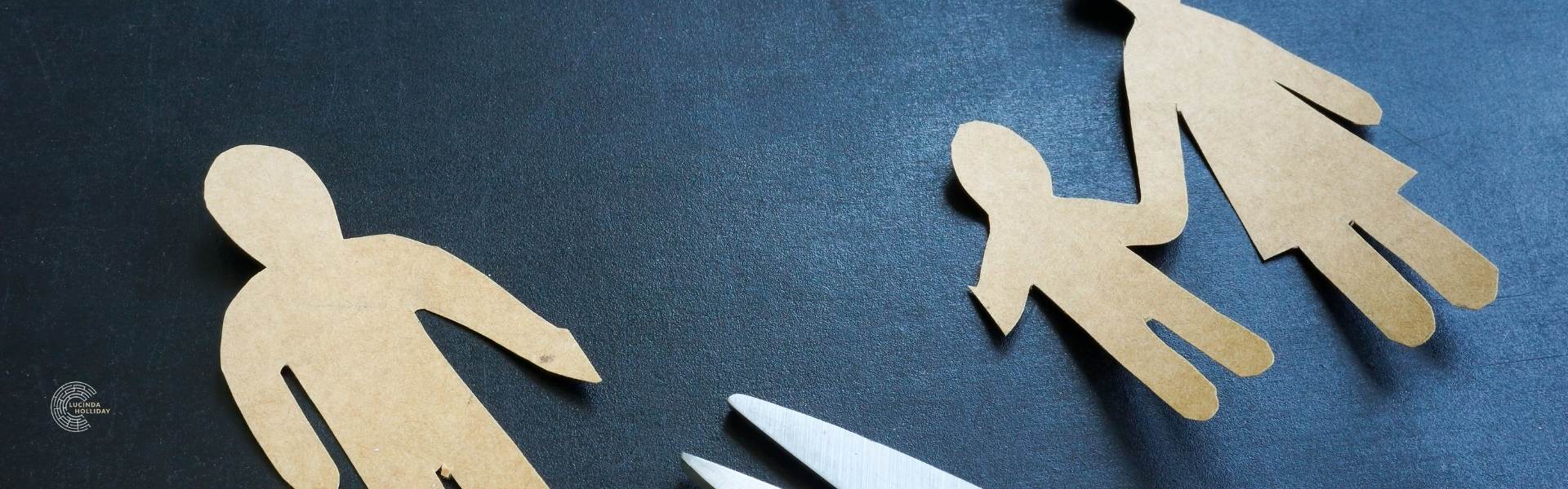 Paper family cut in half by scissors